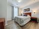 Bedroom with wood flooring and a striped comforter at 1361 Tuscan Ter # 7305, Davenport, FL 33896