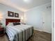 Bedroom with wood flooring and a striped comforter at 1361 Tuscan Ter # 7305, Davenport, FL 33896