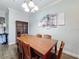 Dining room features a wood table, chairs, and china cabinet at 1361 Tuscan Ter # 7305, Davenport, FL 33896