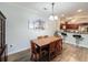 Dining room with a wooden table and chairs, and kitchen views at 1361 Tuscan Ter # 7305, Davenport, FL 33896