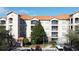 Exterior view of condo building with multiple balconies and a tree at 1361 Tuscan Ter # 7305, Davenport, FL 33896
