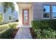 Modern home exterior with red door and landscaped walkway at 16257 Prairie School Dr, Winter Garden, FL 34787