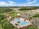Community pool and amenity center surrounded by lush landscaping at 1956 Egret Meadows Ave, Kissimmee, FL 34744