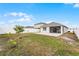 Backyard with patio, landscaping, and white fence at 1956 Egret Meadows Ave, Kissimmee, FL 34744