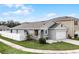 Gray house with white fence and landscaping at 1956 Egret Meadows Ave, Kissimmee, FL 34744