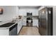 Modern kitchen with stainless steel appliances and white cabinets at 1956 Egret Meadows Ave, Kissimmee, FL 34744
