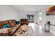 Living room with brown sectional and access to backyard at 1956 Egret Meadows Ave, Kissimmee, FL 34744