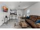 Living room with brown sectional sofa and large TV at 1956 Egret Meadows Ave, Kissimmee, FL 34744