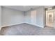 Bedroom with grey carpet, white door and hallway view at 22 Peterlee Ct, Kissimmee, FL 34758