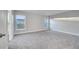 Spacious bedroom with carpet flooring and two windows at 22 Peterlee Ct, Kissimmee, FL 34758