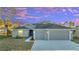 New construction home with two-car garage and landscaped lawn at 22 Peterlee Ct, Kissimmee, FL 34758