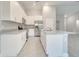 Modern kitchen with island, white cabinets and granite countertops at 22 Peterlee Ct, Kissimmee, FL 34758