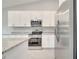 Modern kitchen with white cabinets and stainless steel appliances at 22 Peterlee Ct, Kissimmee, FL 34758