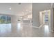 Open floor plan living room with tile floors and sliding glass doors at 22 Peterlee Ct, Kissimmee, FL 34758