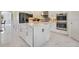 White kitchen with center island and marble countertops at 2239 Pearl Cider St, Orlando, FL 32824