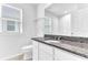 Bathroom with granite countertop and white cabinets at 2274 Centerra Loop, Kissimmee, FL 34741