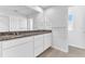 Bathroom with granite double vanity and white cabinets at 2274 Centerra Loop, Kissimmee, FL 34741