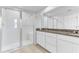 Modern bathroom with granite countertops, a large shower, and white cabinets at 2274 Centerra Loop, Kissimmee, FL 34741