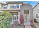 Modern two-story townhome with stone accents and a landscaped front yard at 2274 Centerra Loop, Kissimmee, FL 34741