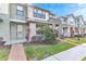 Modern two-story townhome with a welcoming front entrance and nicely landscaped yard at 2274 Centerra Loop, Kissimmee, FL 34741