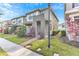Two-story townhome with modern facade, landscaped front yard, and brick pathway at 2274 Centerra Loop, Kissimmee, FL 34741