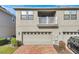Rear view of townhome with garage and balcony at 2274 Centerra Loop, Kissimmee, FL 34741