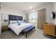 King-size bed, neutral decor, and plenty of natural light at 2621 Bugatti Ct, Kissimmee, FL 34746