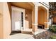 Front entrance of townhome with white door and covered porch at 2621 Bugatti Ct, Kissimmee, FL 34746