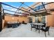 Private patio with hot tub, seating, and umbrella at 2621 Bugatti Ct, Kissimmee, FL 34746