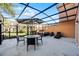 Spacious screened patio with seating area, hot tub, and lush landscaping at 2621 Bugatti Ct, Kissimmee, FL 34746