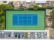 Aerial view of a blue and green tennis court with adjacent parking at 2621 Bugatti Ct, Kissimmee, FL 34746