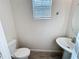 Simple half bathroom with pedestal sink and tile floor at 272 Muscogee Ln, Orlando, FL 32825