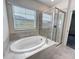 Luxurious bathroom with a soaking tub and glass-enclosed shower at 272 Muscogee Ln, Orlando, FL 32825