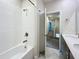Bright bathroom with a combination shower-tub with bronze fixtures and a double sink vanity at 272 Muscogee Ln, Orlando, FL 32825