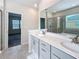 Elegant bathroom featuring double vanity and large mirror at 272 Muscogee Ln, Orlando, FL 32825
