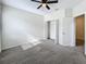 Well-lit bedroom with carpet flooring and double doors leading to closet at 272 Muscogee Ln, Orlando, FL 32825