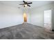 Large bedroom with neutral carpeting, a ceiling fan, and a view into the closet and bathroom at 272 Muscogee Ln, Orlando, FL 32825