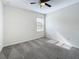 Bright bedroom featuring neutral carpeting, a ceiling fan, and a sunlit window at 272 Muscogee Ln, Orlando, FL 32825