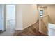 Upstairs hallway with carpeted floors and access to bedrooms at 272 Muscogee Ln, Orlando, FL 32825