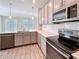 Stylish kitchen with stainless steel appliances and gray cabinetry at 272 Muscogee Ln, Orlando, FL 32825