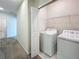Laundry area with appliances including a washing machine, dryer and wire shelves at 272 Muscogee Ln, Orlando, FL 32825