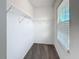 Walk-in closet with carpeted floors, shelving, and a window with natural light at 272 Muscogee Ln, Orlando, FL 32825