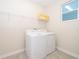 Laundry room with washer, dryer, and shelving at 2733 Bookmark Dr, Kissimmee, FL 34746