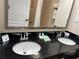 Double sink vanity with a large mirror in the bathroom at 3000 Maingate Ln # 228, Kissimmee, FL 34747