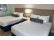 Hotel bedroom with two double beds and modern decor at 3000 Maingate Ln # 228, Kissimmee, FL 34747