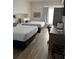 Guest room featuring two beds and wood-look floors at 3000 Maingate Ln # 228, Kissimmee, FL 34747