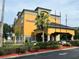 Hotel exterior featuring a multi-story building with ample parking at 3000 Maingate Ln # 228, Kissimmee, FL 34747