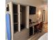 Hotel room workspace with desk, chair, TV, and storage at 3000 Maingate Ln # 228, Kissimmee, FL 34747