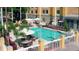 Elevated view of refreshing resort pool with ample lounge chairs at 3000 Maingate Ln # 228, Kissimmee, FL 34747