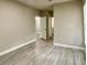 Bright bedroom with wood-look flooring and access to a bathroom at 3011 Hemingway Cir # 3011, Haines City, FL 33844